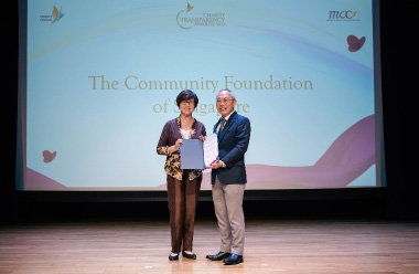 Two people posing with a certificate