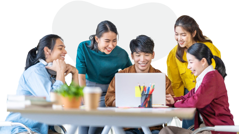 A group of young individuals discussing and looking at laptop