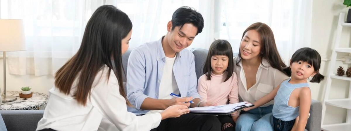 A family signing a document