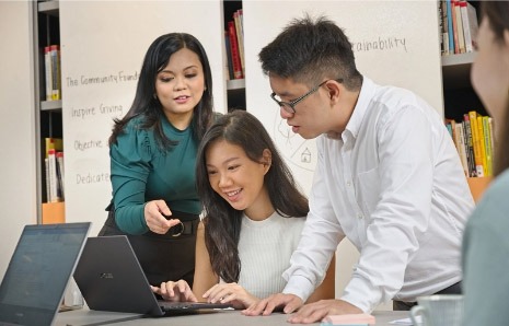 young people looking at a laptop