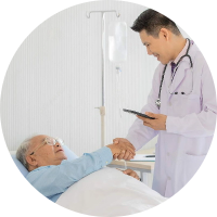 A doctor shaking hands with an elderly person in bed