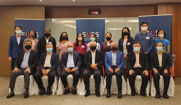 A photo of individuals wearing face masks, posing together for a group picture