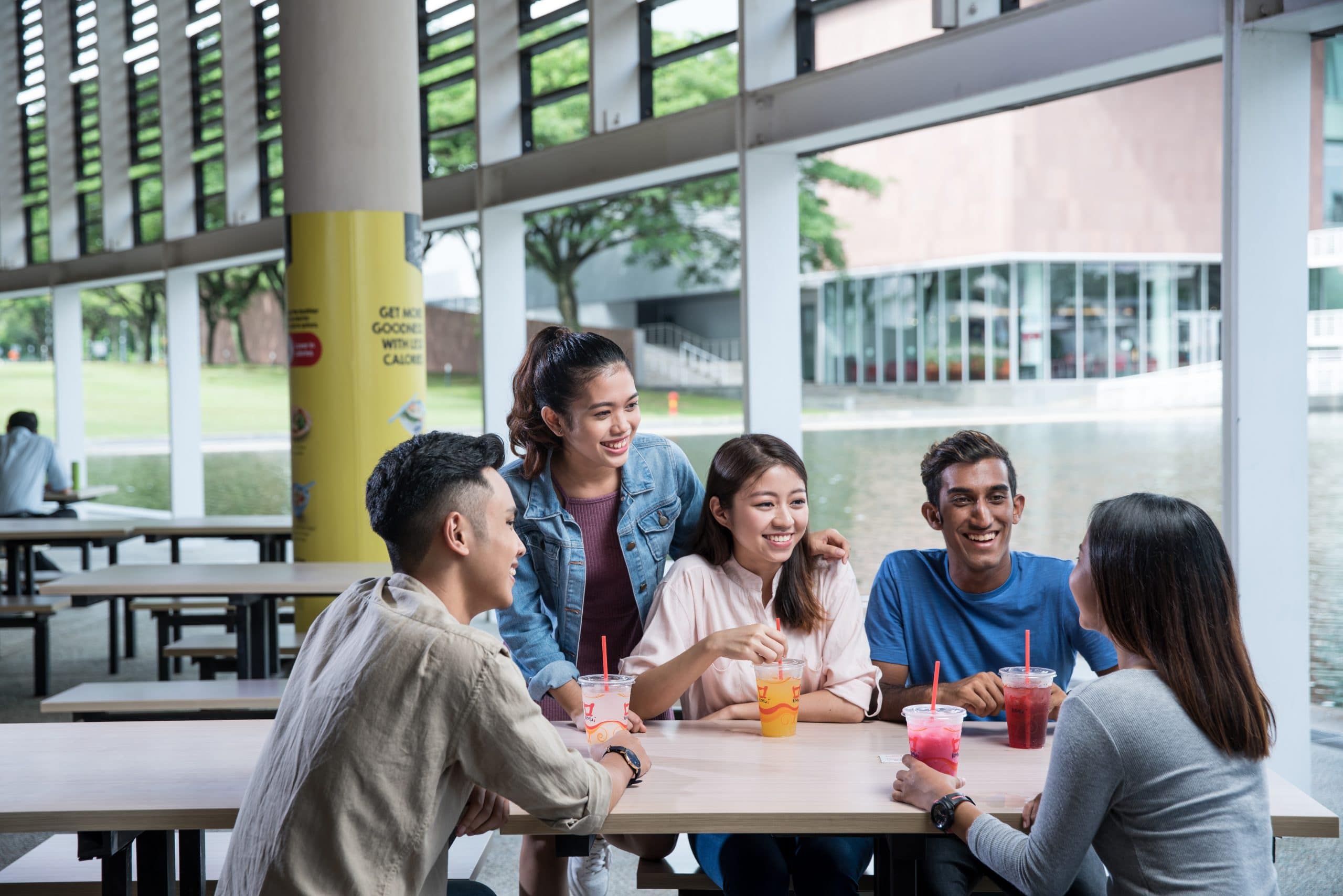 group of friends talking at a bench