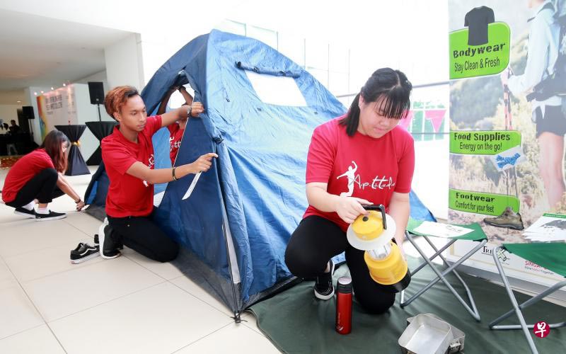 People showcasing how to pitch a tent