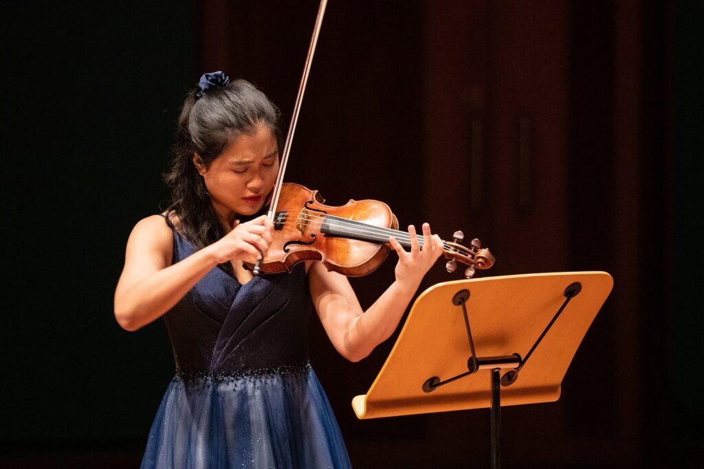 a woman playing a violin