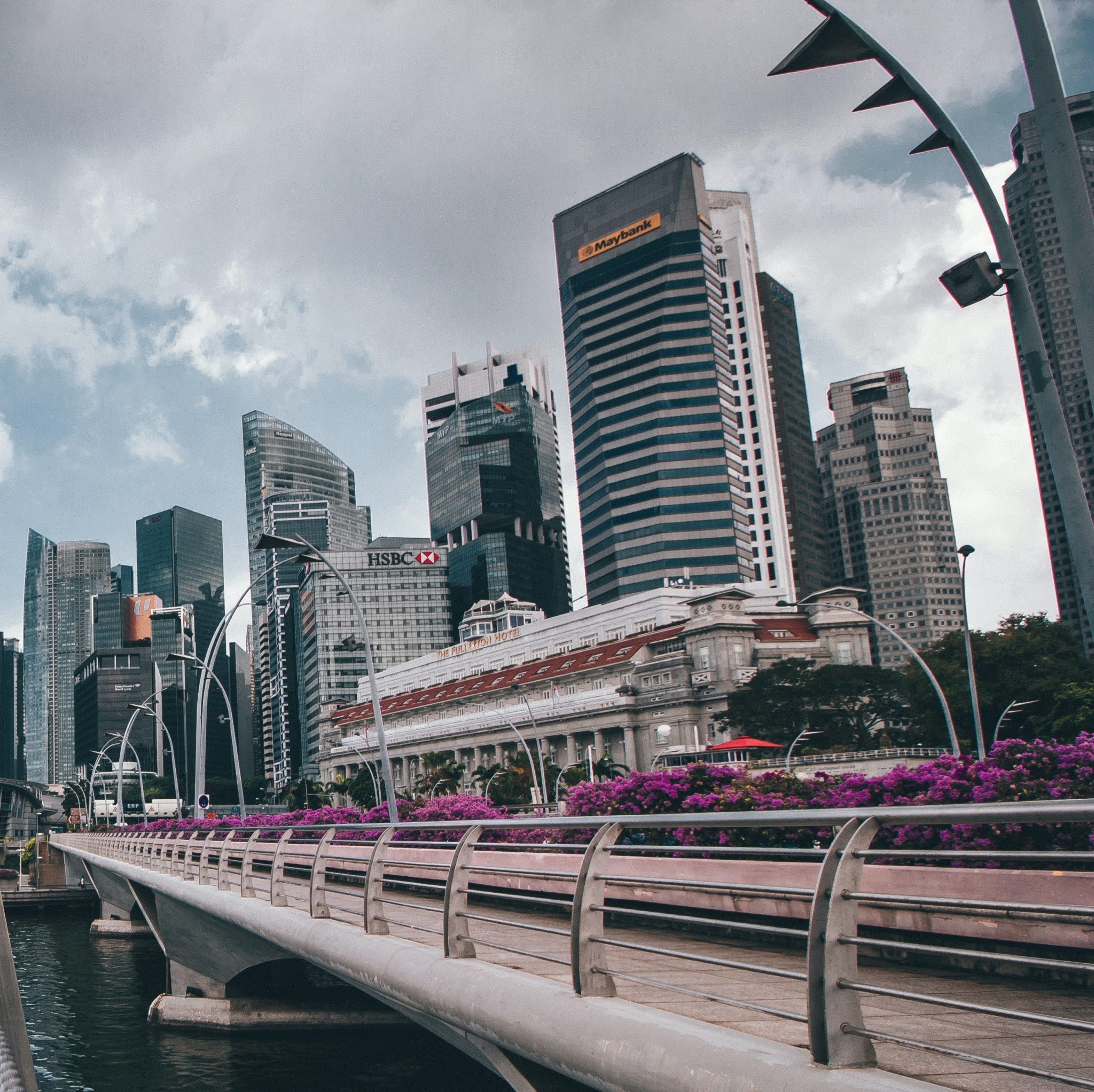 a bridge over water with buildings in the background