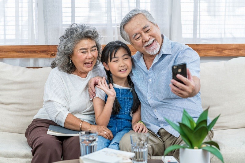 grandparents taking a picture with their grandchild