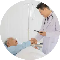 A doctor shaking hands with an elderly person in bed