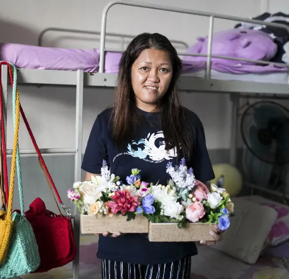 A women posing with flowers