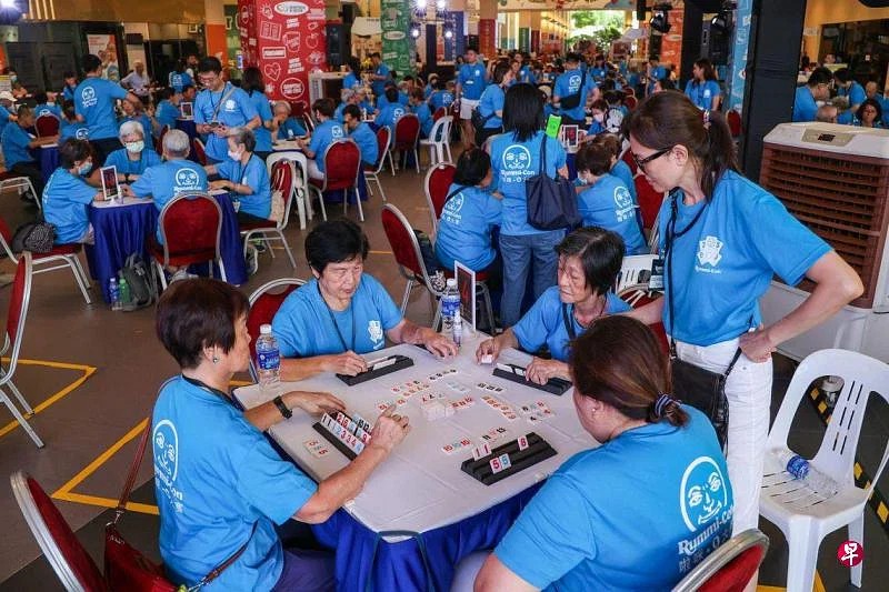 An image capturing a lively game of dominoes being played by a group of individuals, highlighting their enjoyment and competitive spirit.