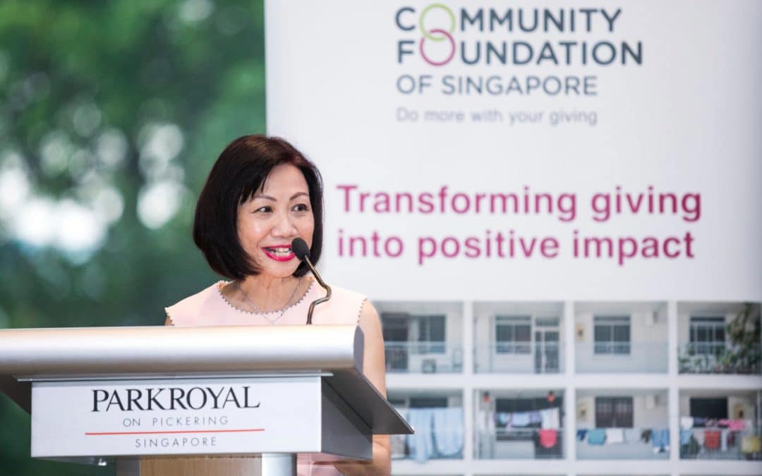 Woman delivering a speech at a podium, inspiring the audience with her words.