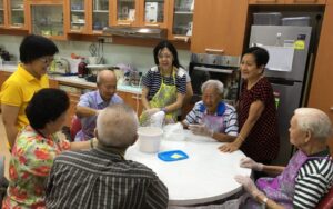 Group of elderly sitting around a round table