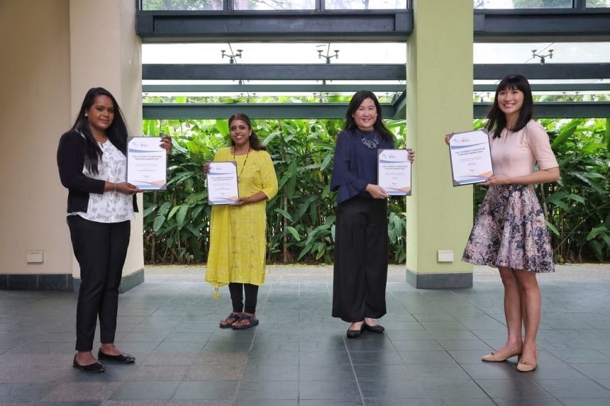 four teachers receiving an award
