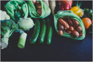 a group of vegetables in green bags