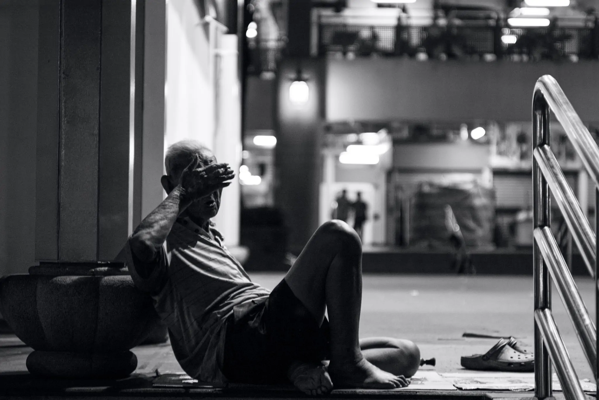 a homeless person sitting on the ground