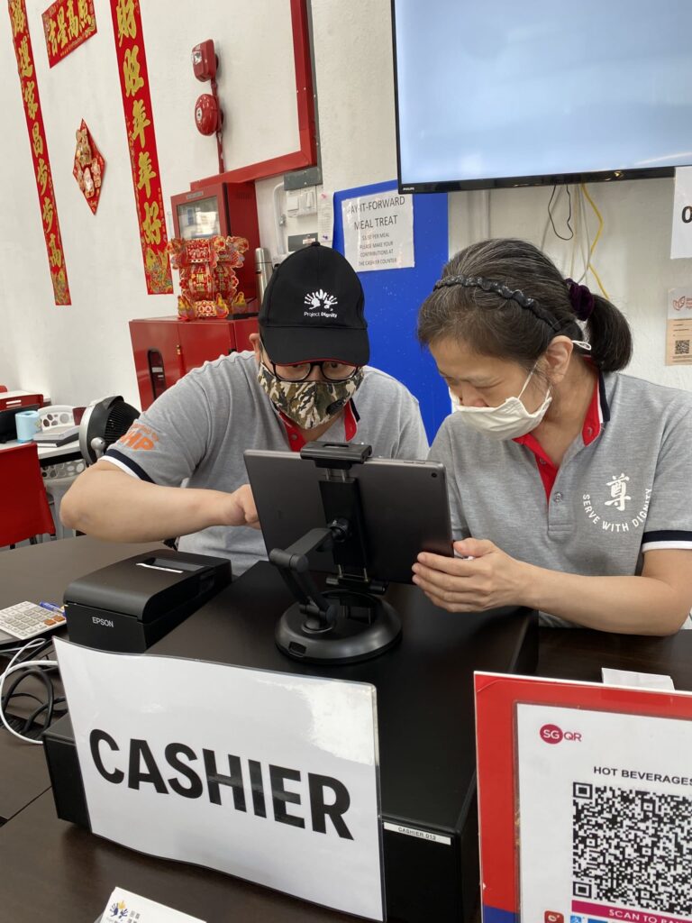 picture of two people doing cashier