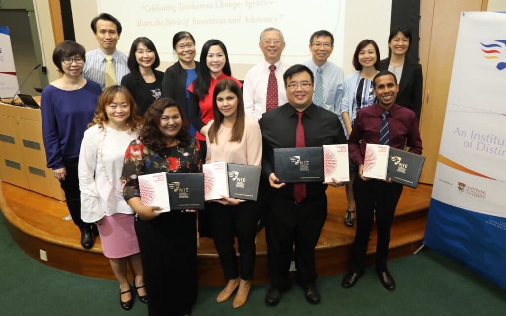 a group of teachers posing with their awards