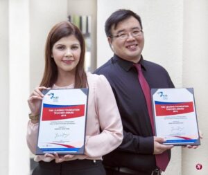 a picture of two teachers holding The Leading Foundation Teacher Award