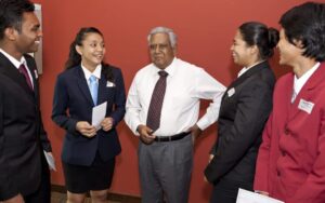 picture of sr nathan with 4 students