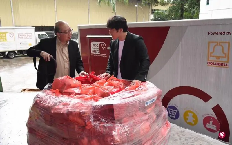 two men standing and talking with red bags