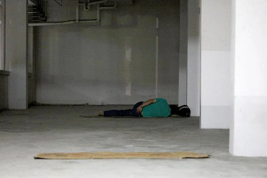 a homeless person lying on the floor